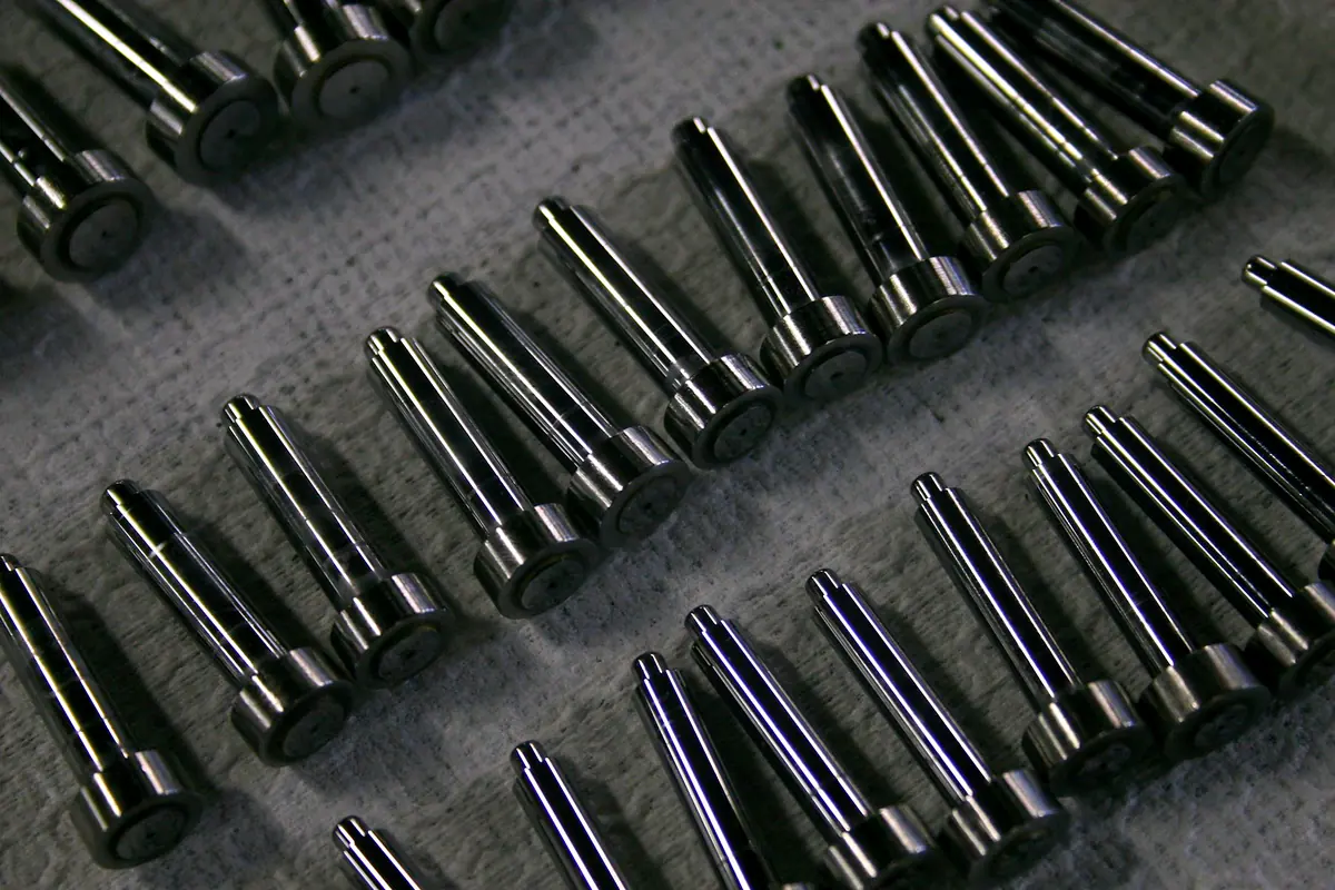 Rows of polished steel pins with fluted tips laid out in a tray