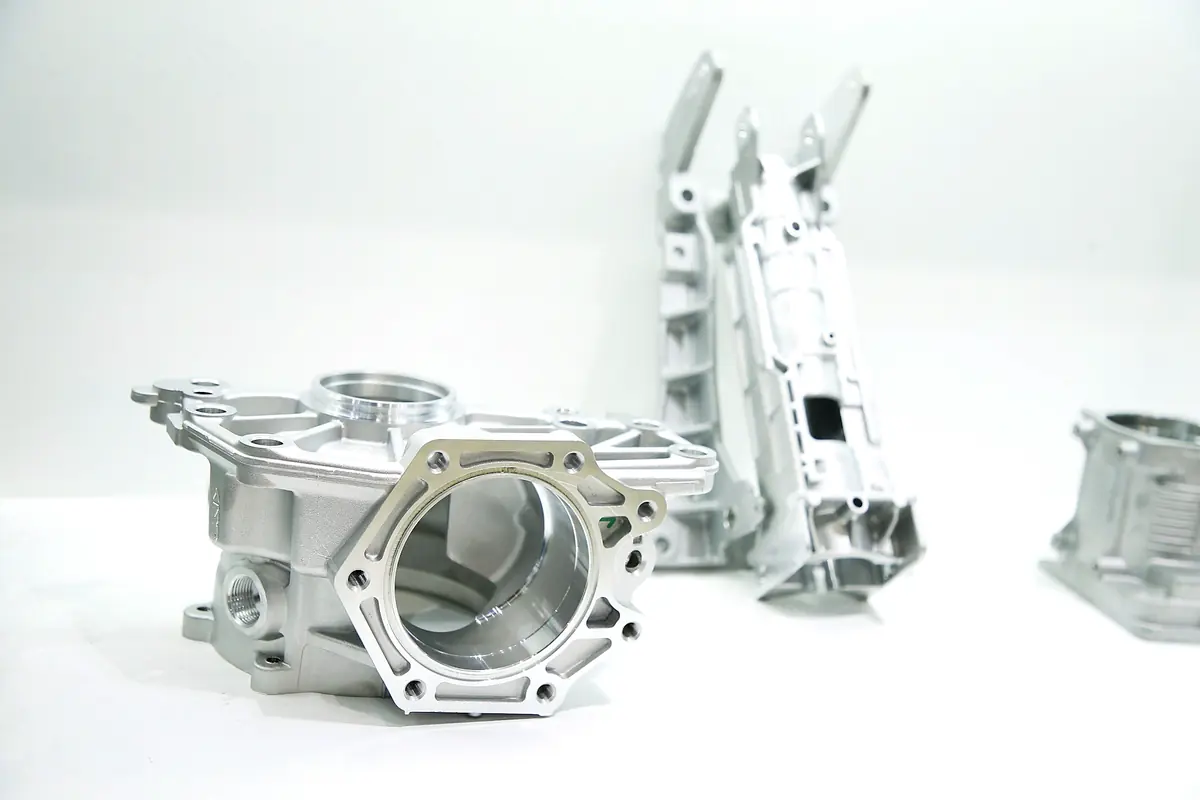 Machined aluminum castings arranged on a white surface